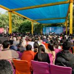 People sitting in rows of chairs at a writers’ festival.